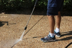 Cleaning the built up dirt out of the driveway joins